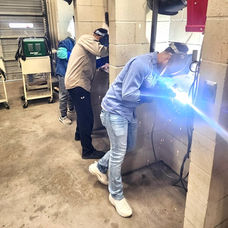 students welding